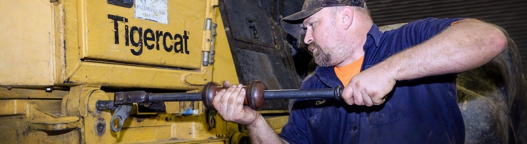Mechanic Working on a Tigercat Machine